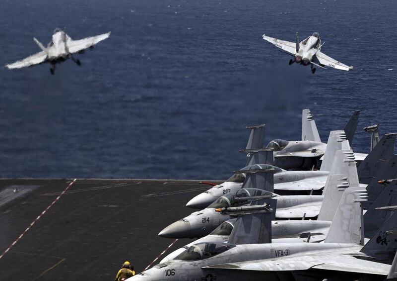 US fighter jets take off for a mission in Iraq from the flight deck of the USS George H.W. Bush in the Arabian Gulf (Photo: AP Photo/Hasan Jamali)