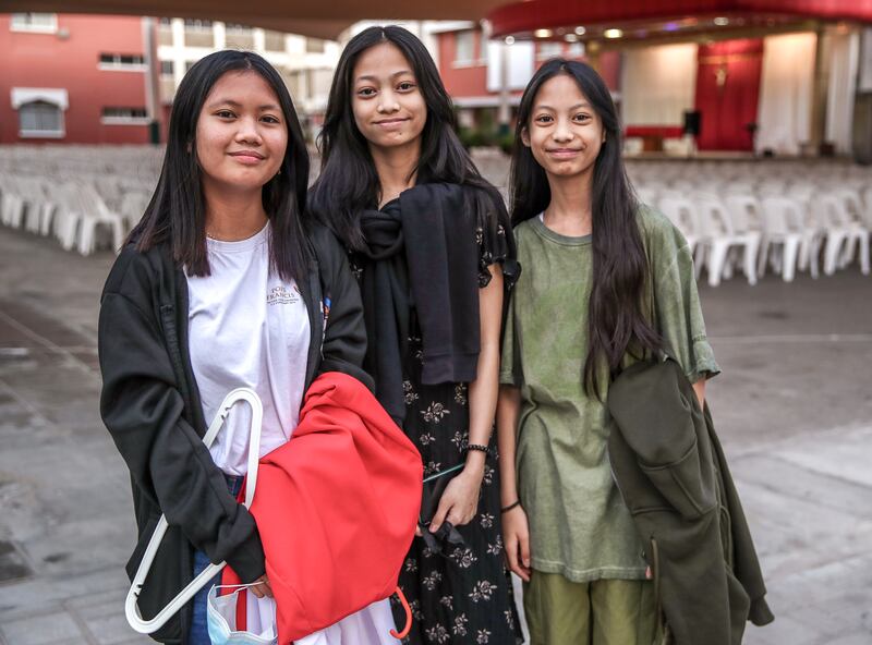 Altar servers, Marielle De Luna and Juliana and Janella Vidal, outside St Joseph's Church in Abu Dhabi. All photos: Victor Besa / The National