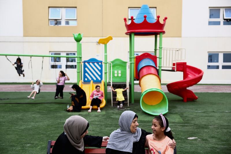 Palestinian evacuee and cancer patient Hanaa Saeed Selim, from Gaza, sits in a playground with her her daughter, who was brought from the U. S.  to accompany her, during the Muslim holy month of Ramadan at Emirates Humanitarian City, in Abu Dhabi, United Arab Emirates, March 19, 2024.  REUTERS / Amr Alfiky