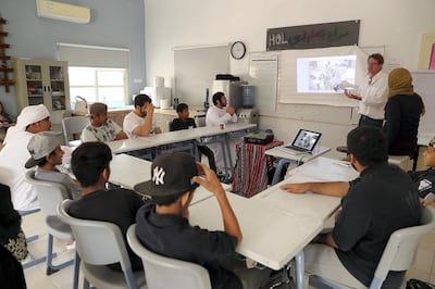 RAS AL KHAIMAH , UNITED ARAB EMIRATES , FEB 21  – 2018 :- Guy Brooksbank ( white shirt right side )  teaching students from Saeed Bin Jubair Secondary School how to take photograph during the photography workshop at the school campus in Ras Al Khaimah. ( Pawan Singh / The National ) For News. Story by Ruba Haza