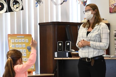 A teacher wearing a mask gives class at Olfa Elsdonk primary school in Edegem, Antwerp, on May 15, 2020 as schools test the re-opening and start again for a limited number of grades on May 18 amid the pandemic of novel coronavirus (COVID-19).  Belgium is in its ninth week of confinement. 
 - Belgium OUT
 / AFP / Belga / DIRK WAEM

