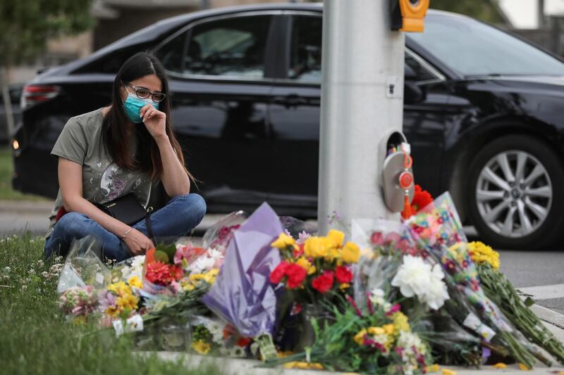 Flowers are laid at the scene where police in London, Ontario, Canada, say a man driving a pick-up jumped the kerb and ran over a Muslim family. Four people were killed. Reuters