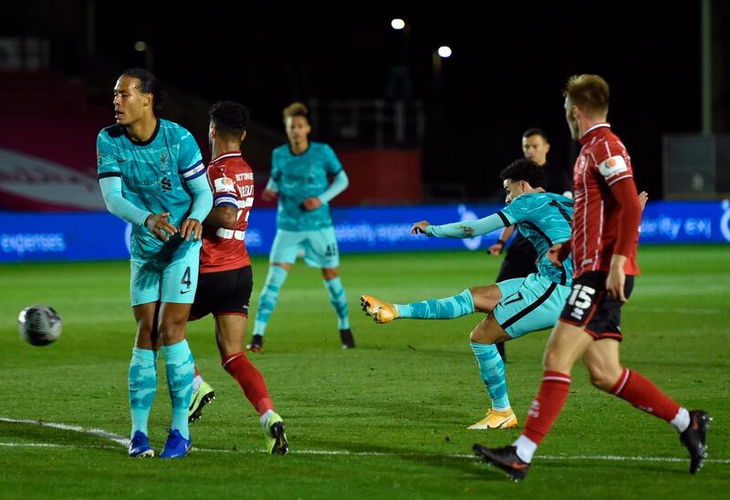 Liverpool's Curtis Jones, second, scores the fourth goal against Lincoln City in the League Cup. EPA