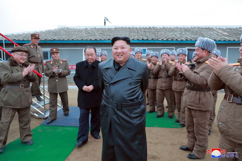 Kim Jong-un is applauded by a military unit after what North Korea claimed was a test firing of its 'super-large' multiple rocket launcher in November 2019. KCNA / AP