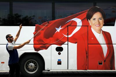 A man takes a selfie next to a bus with a picture of Iyi (Good) Party leader Meral Aksener in Eminonu district in Istanbul, Turkey, June 21, 2018. REUTERS/Alkis Konstantinidis