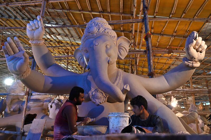Artisans work on an idol of the elephant-headed Hindu god Ganesha for a festival in Mumbai. AFP