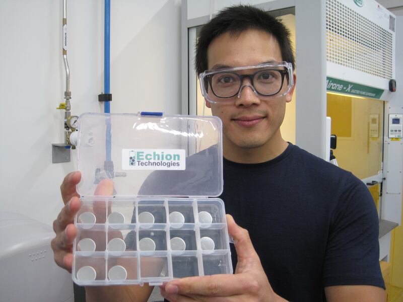 Benjamin Ting, Echion Technologies' chief commercial officer, with coin batteries that contain anode materials that are being tested. Photo: Daniel Bardsley / The National