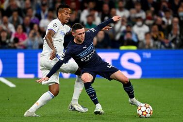 Real Madrid's Brazilian defender Eder Militao vies with Manchester City's English midfielder Phil Foden (R) during the UEFA Champions League semi-final second leg football match between Real Madrid CF and Manchester City at the Santiago Bernabeu stadium in Madrid on May 4, 2022.  (Photo by GABRIEL BOUYS  /  AFP)