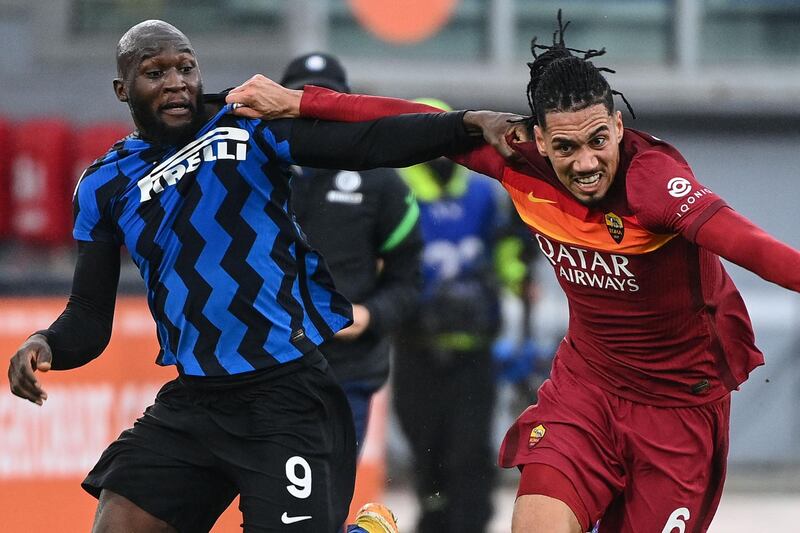 Roma defender Chris Smalling holds off Inter's Romelu Lukaku. AFP