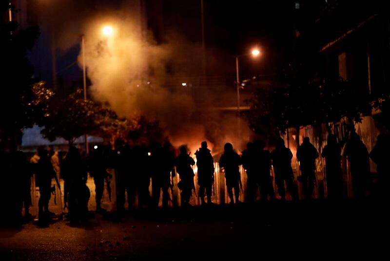 Supporters of Lebanon's Hezbollah and Amal groups clash with security forces late on December 17, 2019 in central Beirut. AFP