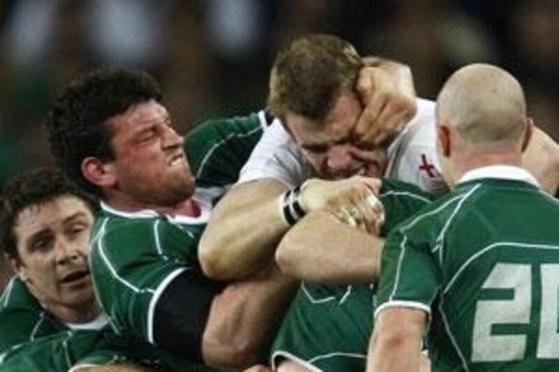 Denis Leamy (second left) of Ireland wrestles with England's Tom Croft during their Six Nations rugby match at Croke Park in Dublin.