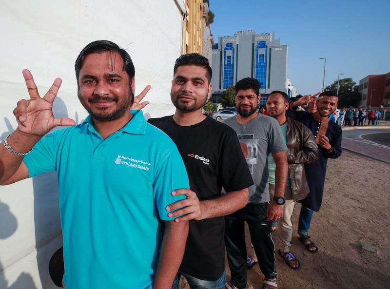 Residents queue outside the iftar tent set up by Emirates Red Crescent and Oxy beside the Abu Dhabi Central Bus Station. Victor Besa / The National