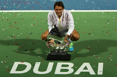 Roger Federer of Switzerland poses with the ATP Dubai Duty Free Tennis Championships trophy after defeating World number one Novak Djokovic of Serbia during their final match on the fifth day of the ATP Dubai Duty Free Tennis Championships on February 28, 2015 in Dubai. AFP PHOTO / MARWAN NAAMANI (Photo by MARWAN NAAMANI / AFP)