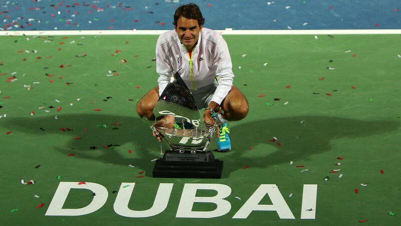 Roger Federer of Switzerland poses with the ATP Dubai Duty Free Tennis Championships trophy after defeating World number one Novak Djokovic of Serbia during their final match on the fifth day of the ATP Dubai Duty Free Tennis Championships on February 28, 2015 in Dubai. AFP PHOTO / MARWAN NAAMANI (Photo by MARWAN NAAMANI / AFP)