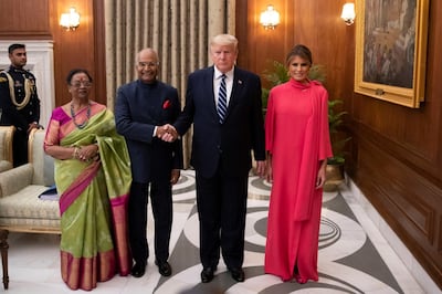 Indian President Ram Nath Kovind and his wife Savita Kovind stand with President Donald Trump and first lady Melania Trump as they arrive for a state banquet at Rashtrapati Bhavan, in New Delhi, India February 25, 2020.  Alex Brandon/Pool via REUTERS