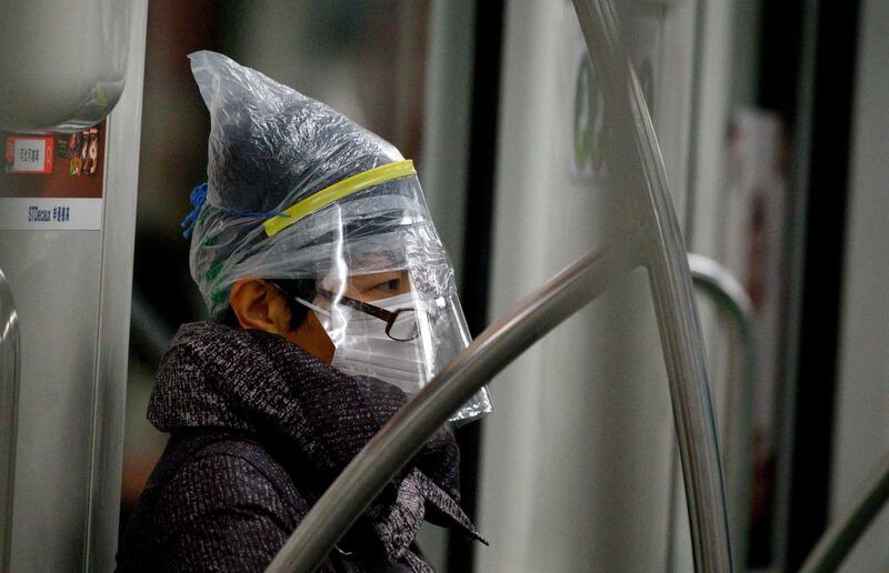 A subway passenger wears a facemask among other protective items in Shanghai. AFP