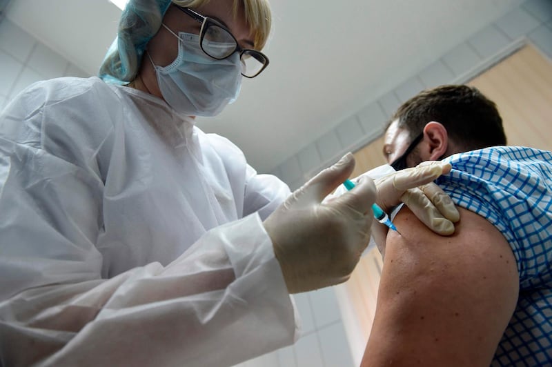 A nurse inoculates volunteer Ilya Dubrovin, 36, with Russia's new coronavirus vaccine at a clinic in Moscow. AFP