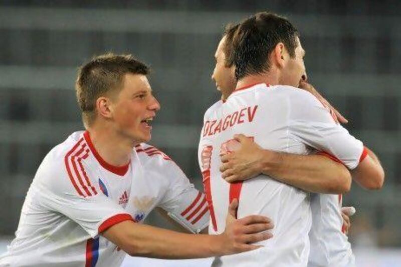 Russia's Alan Dzagoev, right, Alexander Kerzhakov, centre, and captain Andrey Arshavin, left, celebrate after scoring the first goal against Italy in an international friendlly in preparation for Euro 2012. Sebastian Feval / AFP