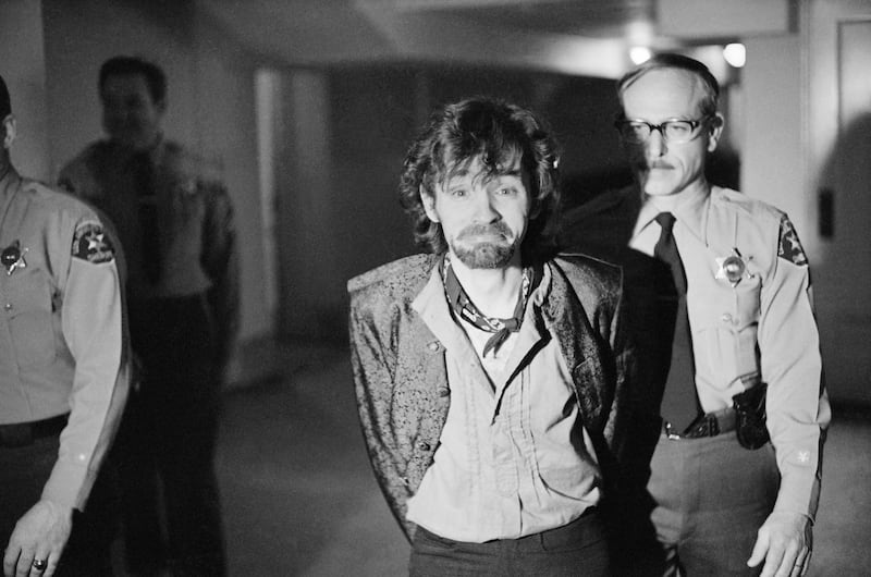 Charles Manson reacts to photographers at trial in 1970. George Brich / AP Photo