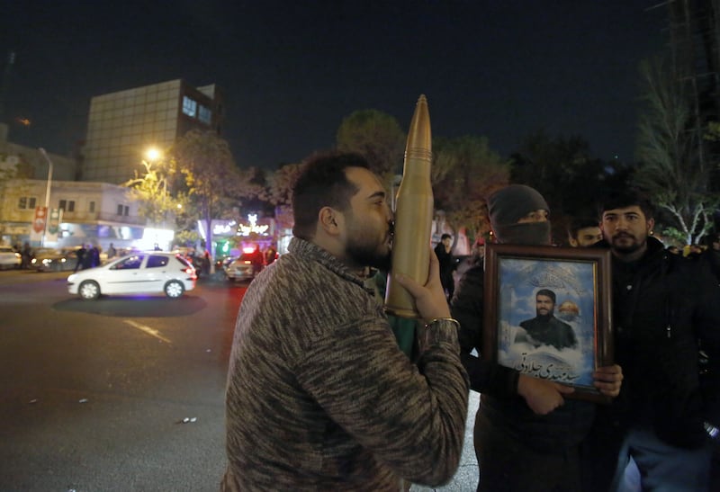 A man kisses a mock rocket during an anti-Israel rally in Tehran after Iran launched the attack. EPA