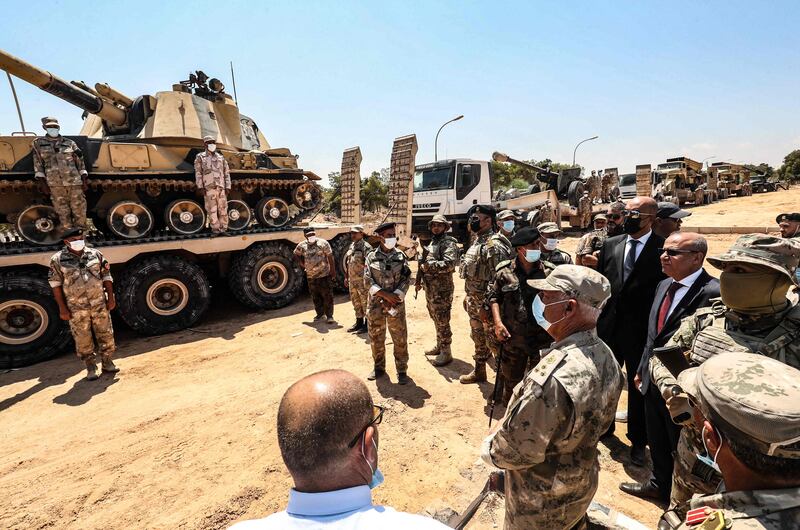 Members of Libya's presidential council, Moussa Al Koni, left, and Abdullah Al Lafi, visit the military camp.