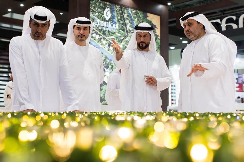 Abu Dhabi, United Arab Emirates, April 19, 2017:     Mohamed Al Qubaisi, right, chairman of Manazel Real Estate speaks to visitors during Cityscape Abu Dhabi at Abu Dhabi National Exhibition Center in Abu Dhabi on April 19, 2017. Christopher Pike / The National

Job ID: 46714
Reporter: Lucy Barnard
Section: Business
Keywords: *** Local Caption ***  CP0419-bz-cityscape-03.JPG