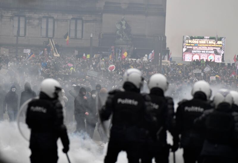 Police use water cannon to push back protesters near the headquarters of the EU in Brussels. AP