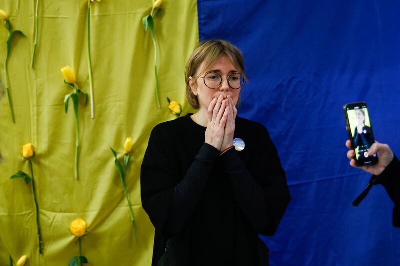 Ukrainian designer Lilia Litkovskaya speaks to the press about the situation in Ukraine, in front of the Ukrainian national flag at the Palais de la Bourse. Litkovskaya fled Kyiv on the day of Russia's invasion of Ukraine with her daughter aged 2, without the team or her collection. EPA