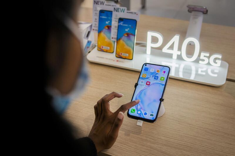 A customer tests a Huawei P40 5G-ready smartphone on display inside a Huawei Technologies Co. store at Menlyn Park Shopping Center in Pretoria, South Africa, on Wednesday, Aug. 12, 2020. Telecom company Rain said it has set up South Africa's first commercial fifth-generation mobile network in two large cities using equipment from China's Huawei. Photographer: Waldo Swiegers/Bloomberg