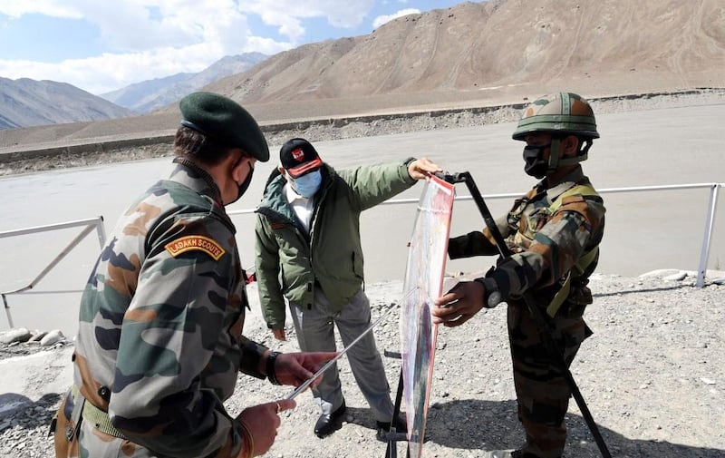 Prime Minister Narendra Modi looks at a map during his visit to Ladakh, where 20 Indian army personnel, including a colonel, were killed in clashes with Chinese troops in the Galwan Valley in June 2020.  EPA