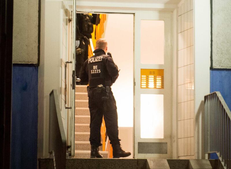 Policemen enter a residential building in Berlin's Marzahn-Hellersdorf district, where they carried out a raid, on January 14, 2020. German police carried out raids on suspected Islamist militants across the country early Tuesday, January 14, over allegations they were plotting a violent attack, Berlin officials said. German authorities are on high alert for Islamist threats to Europe's most populous country, which has in recent years suffered several attacks.
 - Germany OUT
 / AFP / DPA / DPA / Dennis BRAETSCH
