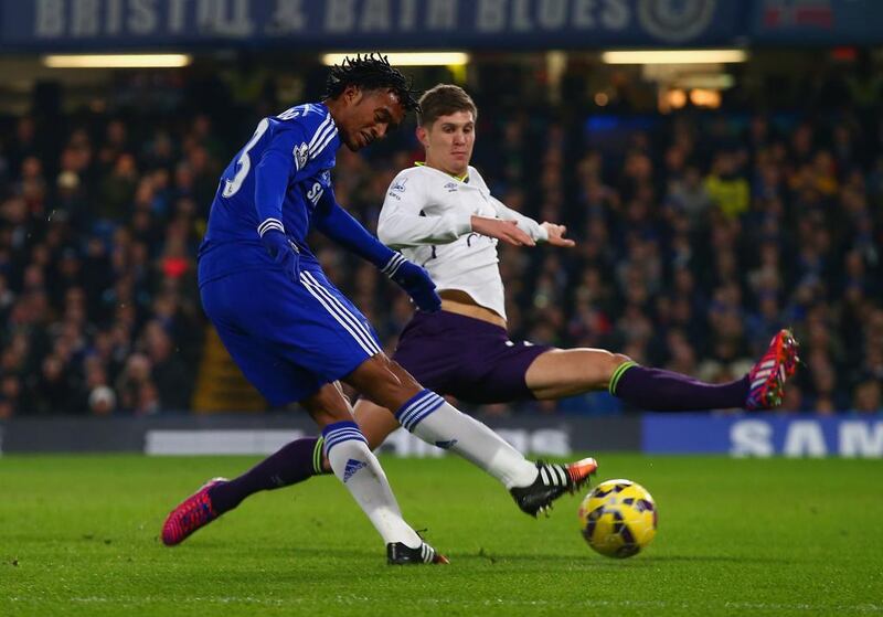 Everton John Stones, in white, blocks Chelsea’s Juan Cuadrado, but his club is now trying to deny a bid for him. Clive Rose / Getty Images