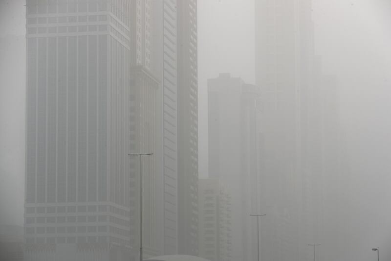 Buildings on Sheikh Zayed Road were hidden by a blanket of sand. Pawan Singh / The National.