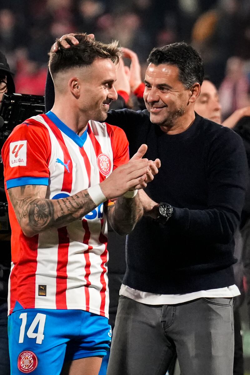 Girona's head coach Michel celebrates with Aleix Garcia after they beat Atletico Madrid 4-3. EPA