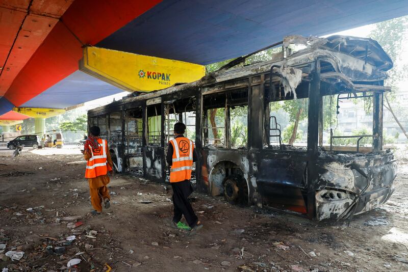The shell of a bus set on fire during protests in Karachi. Reuters