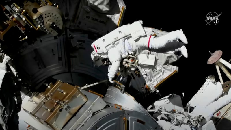 In a still image from a video, astronauts conduct a spacewalk to replace a faulty antenna on the International Space Station on December 2, 2021. Reuters 