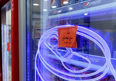 A sign reading: ' Warning: This product is boycotted.  The choice is yours. ' is seen at a supermaket in Amman. Reuters