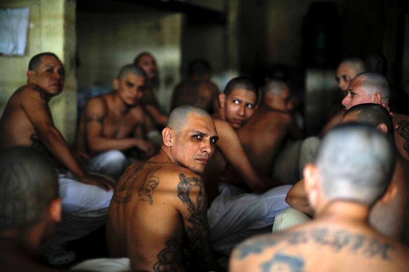 Gang members sit inside a cell at Izalco jail during a 24-hour lockdown ordered by El Salvador's President Nayib Bukele after a high number of homicides, during the quarantine to prevent the spread of the coronavirus disease, in Izalco, El Salvador. Reuters