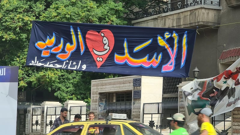 A banner in Bagdad street reads "Assad in my veins" 