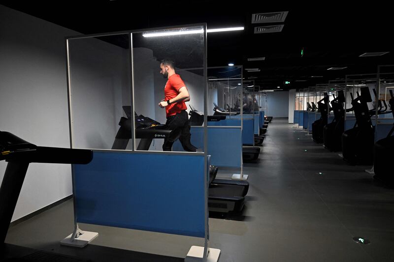 An athlete uses treadmill in the fitness centre at Beijing 2022 Winter Olympic Games village. AFP