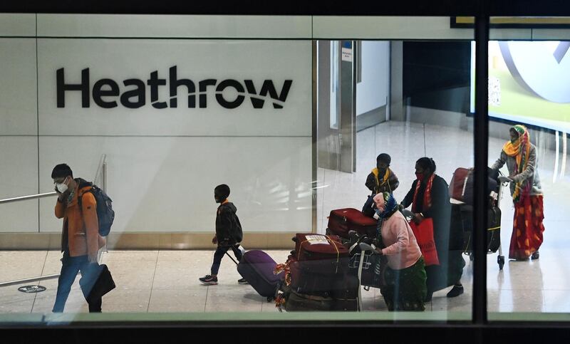 Travellers arrive at Heathrow Airport in London. EPA