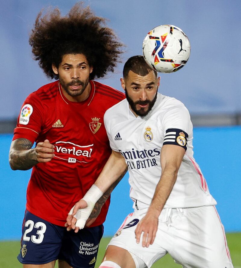 Real Madrid's Karim Benzema under pressure from Aridane Hernandez of Osasuna. EPA