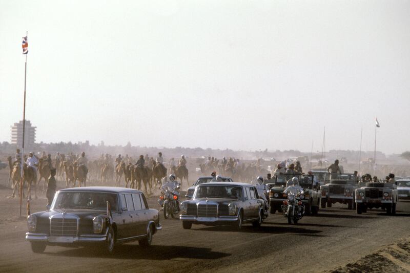 The royal motorcade arrives at the desert air strip in Al Ain, Abu Dhabi, where Queen Elizabeth II watched camel racing events on the latest stage of her three week tour of the Gulf.