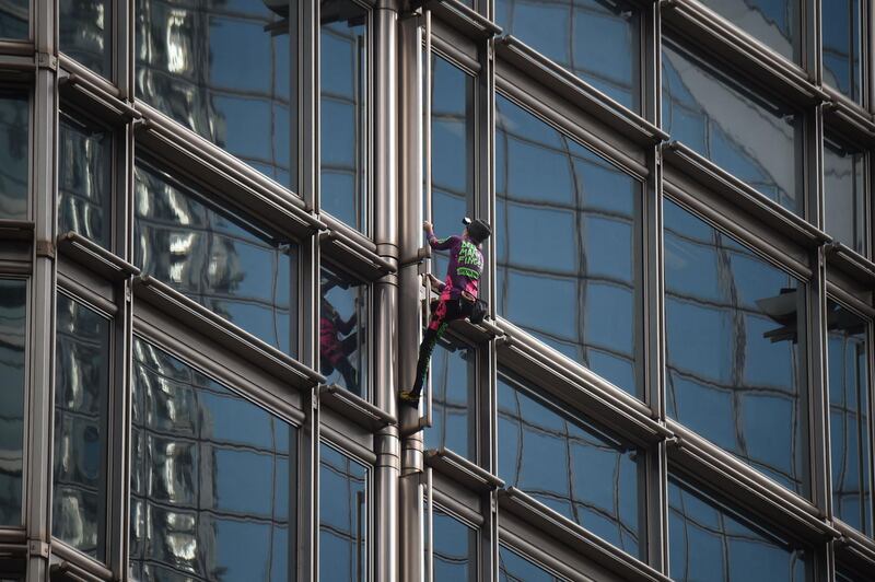 Robert climbs the Cheung Kong Center building. AFP