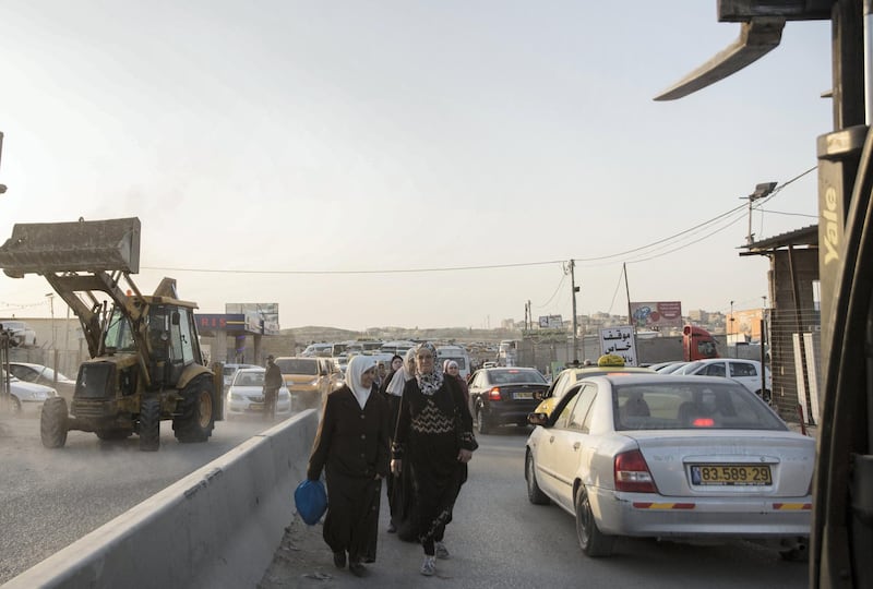 Palestinian women of all ages head towards the chaotic   Qalandia checkpoint to pray in Jerusalem on May 17,2019. The Friday mornings during Ramadan is the most crowded foot traffic time at Qalandia, as tens of thousands of Palestinians from all around the West Bank cross through to pray in Jerusalem. Photo by Heidi Levine for The National).