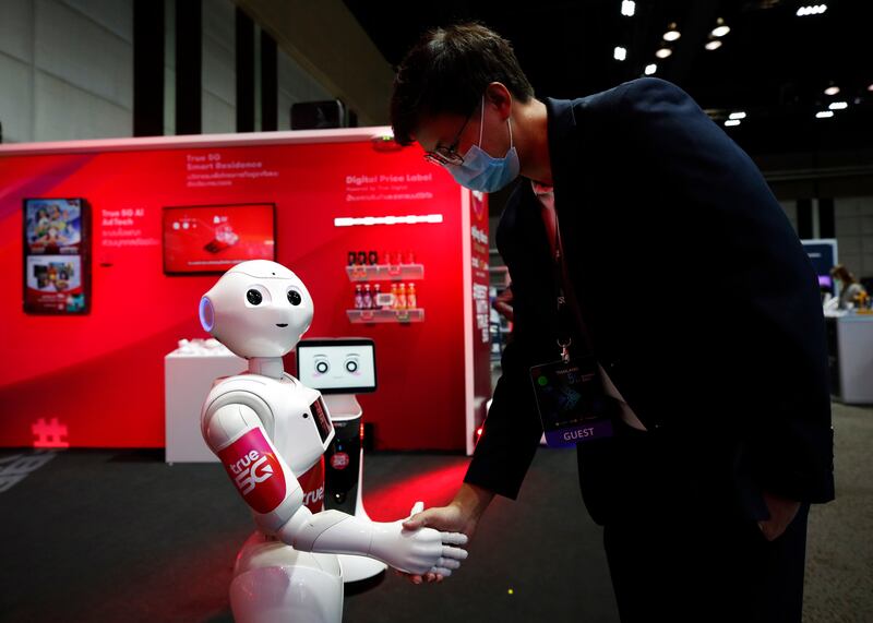 A robot interacts with a visitor during a Thai summit on superfast connectivity. Artificial intelligence and the expansion of the middle class in Asia are major opportunities for investors. EPA