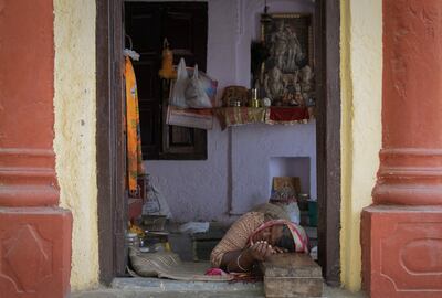 A woman sleeps in the entrance to a Hindu temple as temperatures soar in New Delhi on Wednesday. Reuters
