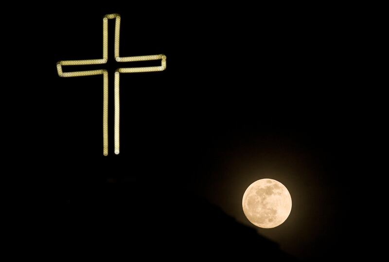 The so-called Super Blood Wolf Moon rises over the cross of the orthodox church Holy Mary Perybleptos in the city of Ohrid, in the former Yugoslav Republic of Macedonia. EPA