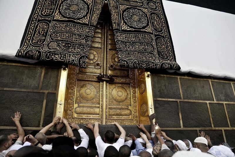 Muslim pilgrims touch the golden door of the Kaaba, Islam’s holiest shrine, at the Grand Mosque in Mecca, Saudi Arabia. Millions of pilgrims have arrived to Mecca ahead of the Haj annual pilgrimage which begins on Saturday. Nariman El-Mofty / AP Photo
