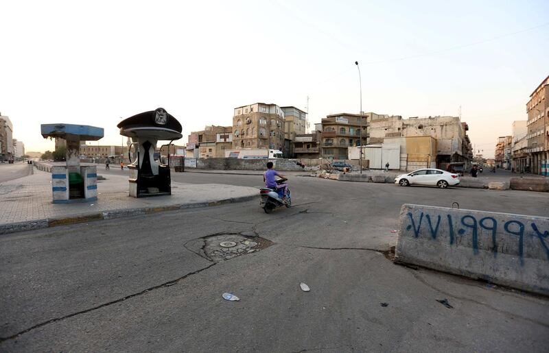 An Iraqi man rides his motorcycle at a mostly empty street during curfew in central Baghdad, Iraq.  EPA